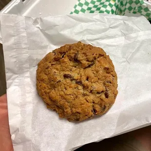 a hand holding a chocolate chip cookie