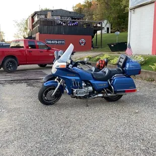 a blue motorcycle parked in a parking lot