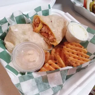 Buffalo chicken wrap with ranch on the side, waffle fries and seasoned sour cream