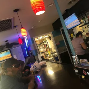 two people sitting at a bar
