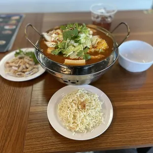 HOT POT selection  tomato, pork belly, intestines with instant noodles . Comes with sweet tea.