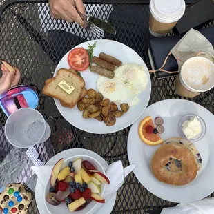 a man eating breakfast at an outdoor table