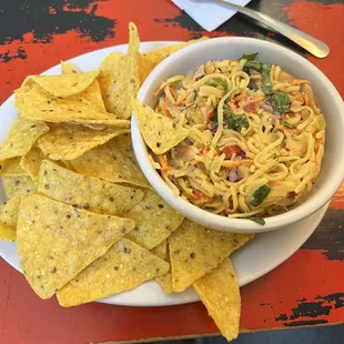 a bowl of pasta with tortilla chips