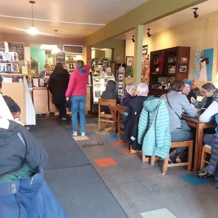 people sitting at tables in a cafe