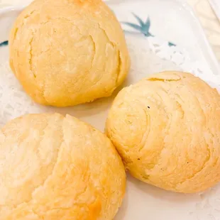 three rolls of bread on a plate