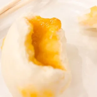 a chinese dumpling on a plate with chopsticks