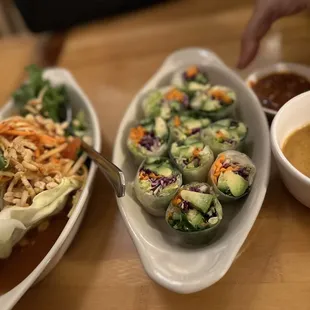 two plates of food and a bowl of sauce