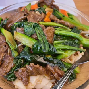 Beef and Chinese broccoli chow fun with sauce.