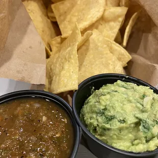 Made in house chips and medium salsa and guacamole.
