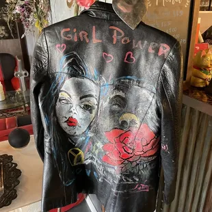 a leather jacket with graffiti on it