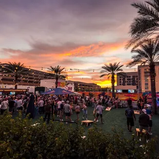 a crowd of people at sunset