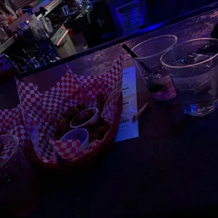 a basket of donuts and a glass of water