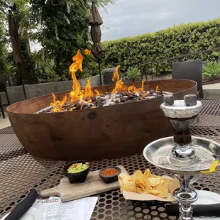 a fire pit and a glass of wine