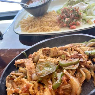 Chicken fajita with rice and bean side.