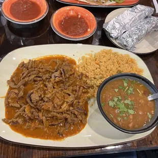 Bottom: Red Chili Colorado with rice and Charro beans and a side of hot tortillas. Top of picture: Veggie Quesadilla