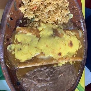 a plate of enchiladas and rice