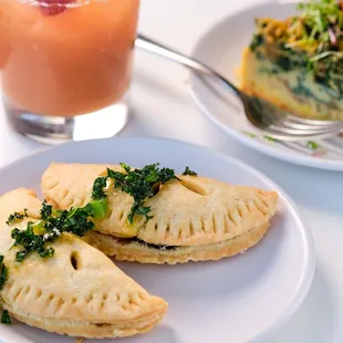 a plate of empanadas and a drink