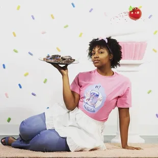 a woman holding a plate of cake