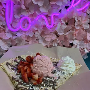 Crepe with fresh strawberries, scoop of  ice cream, Nutella, condensed milk, whipped cream