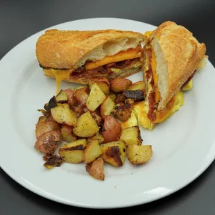a sandwich and potatoes on a plate
