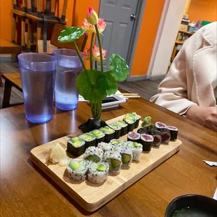 a plate of sushi and a glass of water