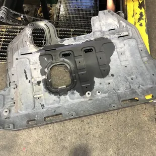 This the undercarriage cover, full of oil.