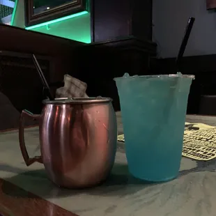 a pitcher and a cup on a bar