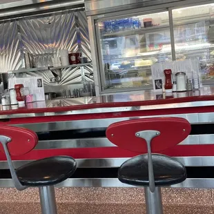 Bar seating and dessert fridge.