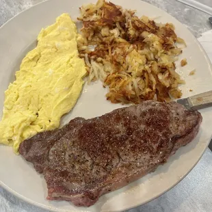 Sirloin steak cooked perfectly to medium rare with hashbrowns and scrambled eggs- all cooked in butter, for the win!