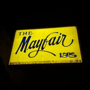 a neon sign for the mayfair lounge