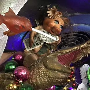 a statue of a girl riding a crocodile with a sword