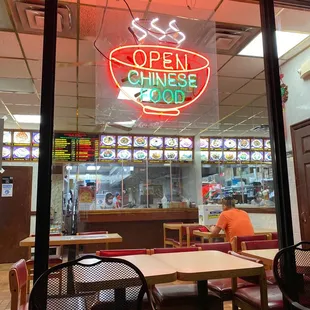 a neon sign in the window of a chinese restaurant