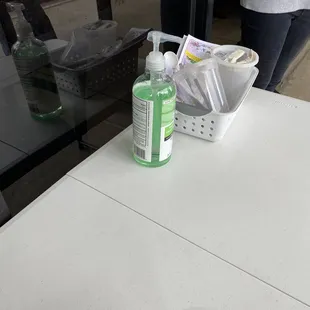 a white table with a bottle of hand sanitizer on it