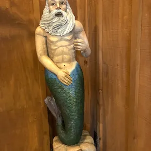 a statue of a man dressed as a mermaid