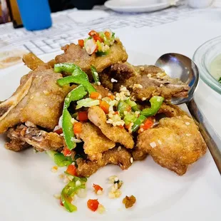 a plate of fried tofu and broccoli