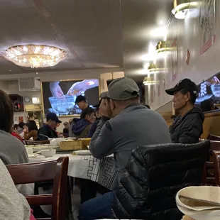 people sitting at tables in a restaurant