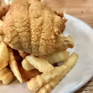 Delicious golden fried catfish with fries and hush puppies.