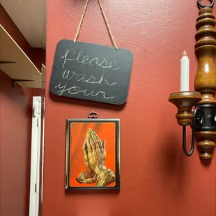 a picture of a candle and a sign on a wall