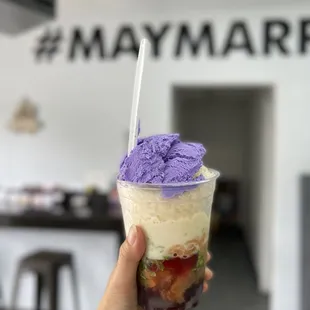 a hand holding a cup of ice cream