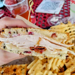 a person holding a half eaten sandwich