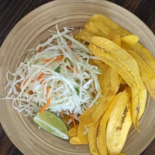 Tajadas is one of our side dishes, served here with cabbage salad and your choice of mayokechu sauce.