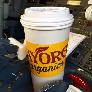 a cup of coffee on a flight deck