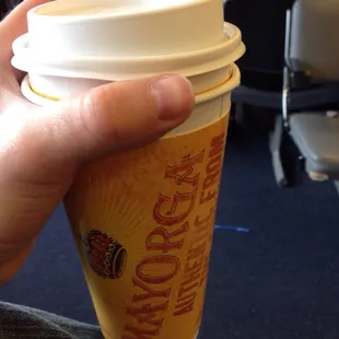 a hand holding a coffee cup