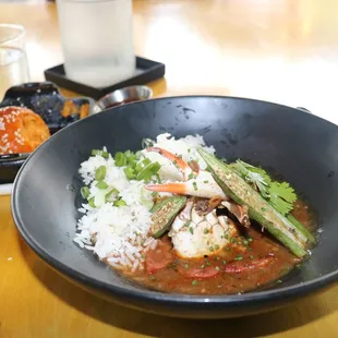 BLUE CRAB AND FERMENTED BLACK BEAN GUMBO roasted okra, andouille sausage, rice fritters...AWESOME annatto sesame rolls with coconut!