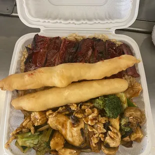 a takeout container with a variety of foods