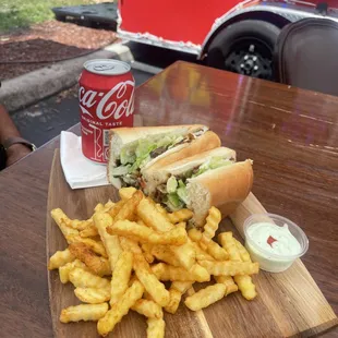 Philly cheesesteaks with fries with garlic sauce on the side