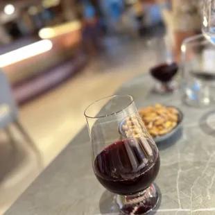 a glass of red wine on a table