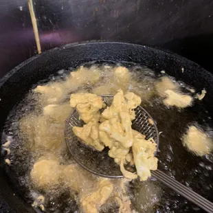 CAULIFLOWER FRITTERS:  cauliflower in a light Batter.  One of the many street foods of India. Great with a chilled Beer.