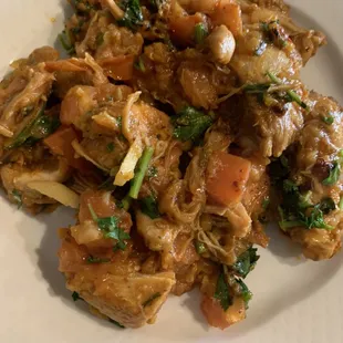 CHICKEN BHOONA: chicken with tomatoes and vegetables. Generously garnished with ginger.