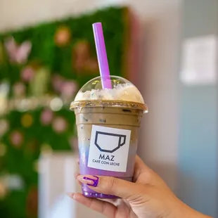 a hand holding a cup of coffee